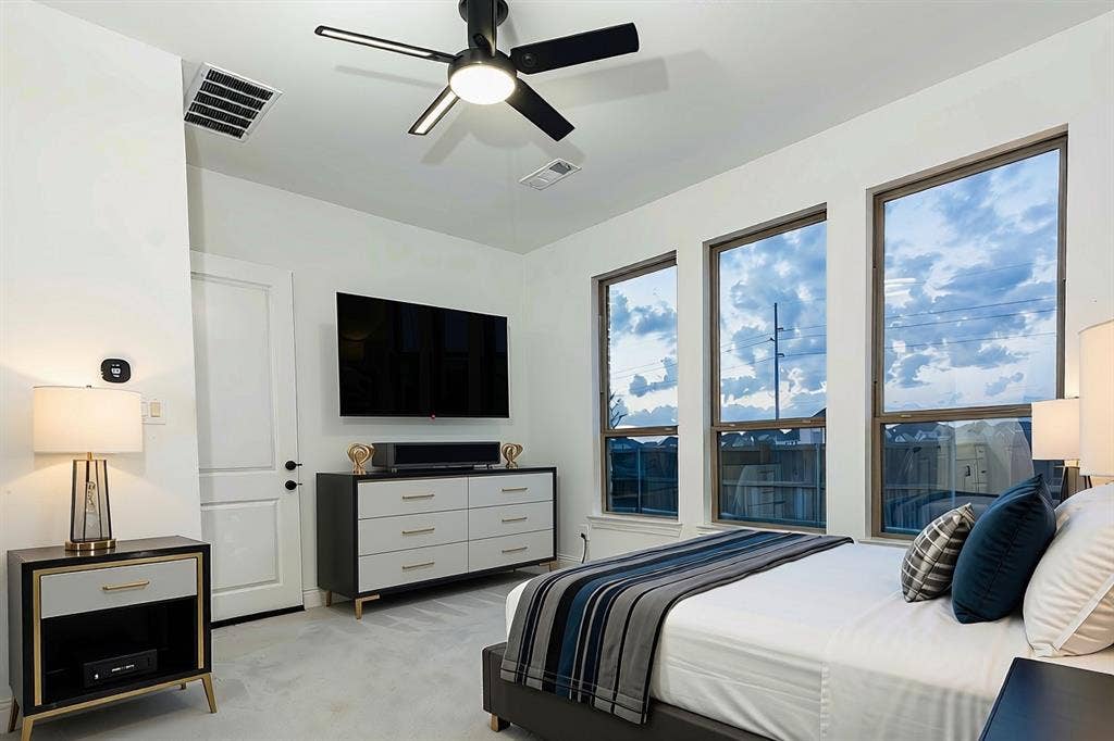415 Rock Rose Lane, Wylie, TX 75098 Bedroom concept featuring three large windows, neutral wall color, and a matte black ceiling fan with an integrated light fixture