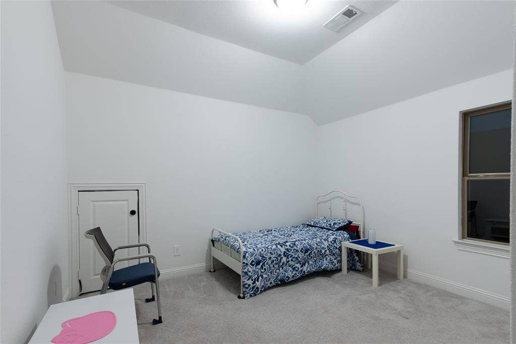 415 Rock Rose Lane, Wylie, TX 75098 Vaulted ceiling featuring neutral wall paint, carpeted flooring, and a dedicated attic access panel