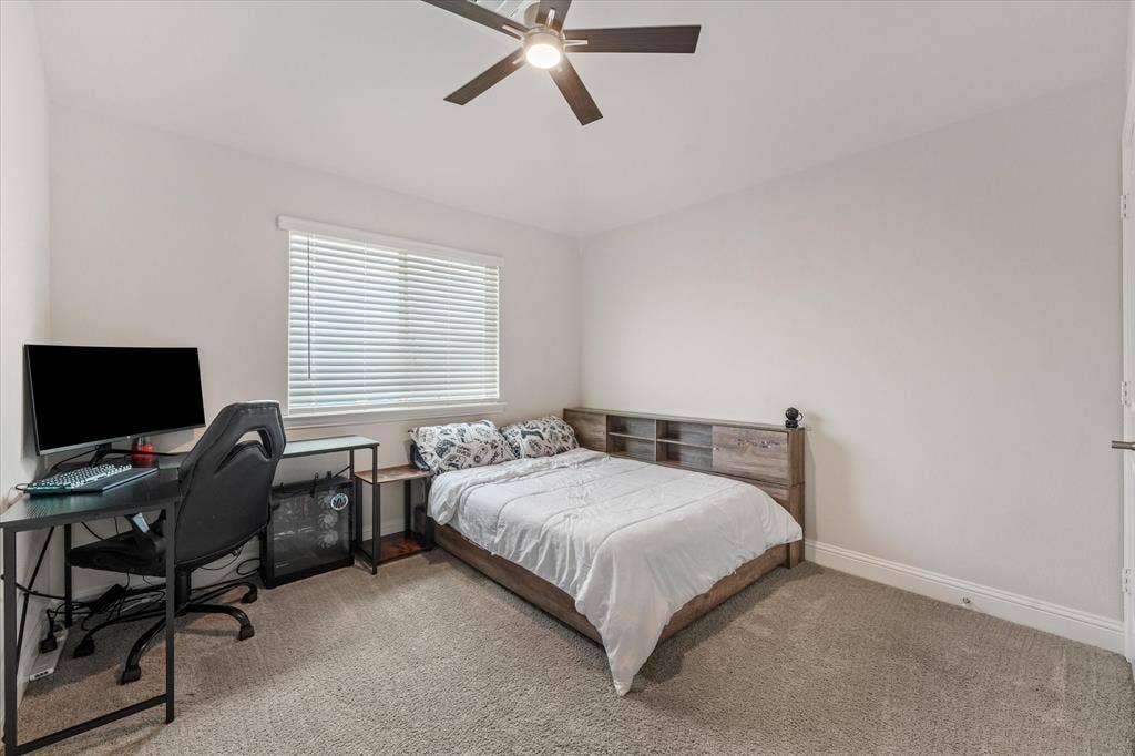 1958 Snowball Lane, Glenn Heights, TX 75154 Bedroom 2 featuring neutral-toned carpeting, a ceiling fan with integrated lighting, and a window with horizontal blinds