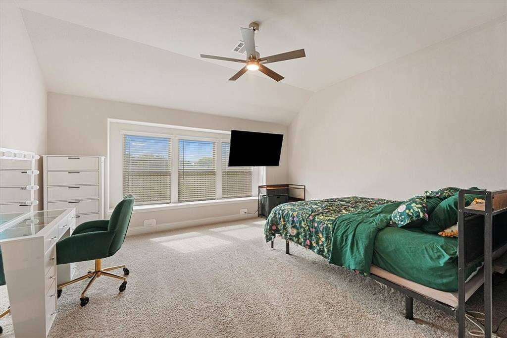 1958 Snowball Lane, Glenn Heights, TX 75154 Vaulted ceilings, expansive three-panel window configuration, neutral carpeting, and a central ceiling fan with integrated lighting