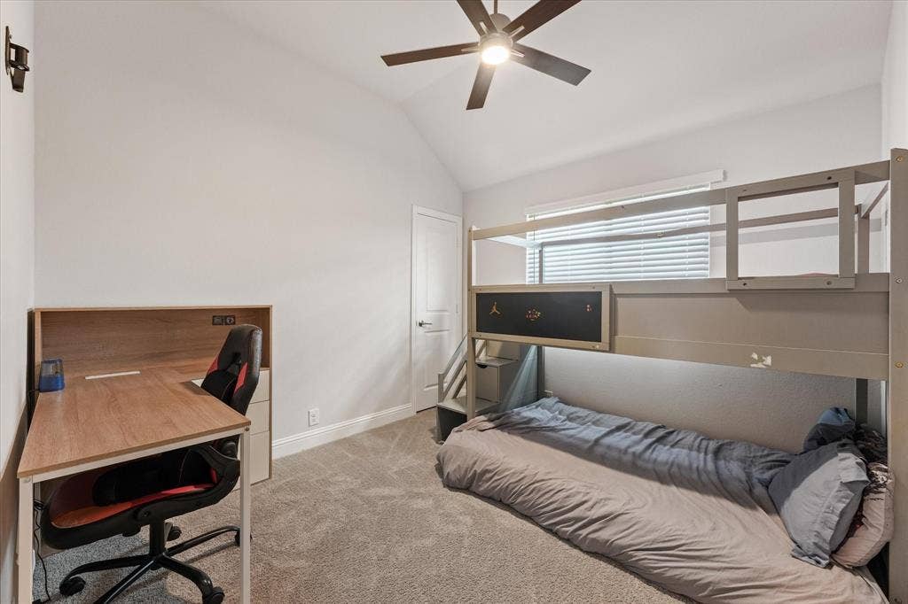 1958 Snowball Lane, Glenn Heights, TX 75154 Bedroom 3 Vaulted ceiling featuring a central multi-blade ceiling fan, wall-to-wall carpeting, and a multi-pane window with horizontal blinds