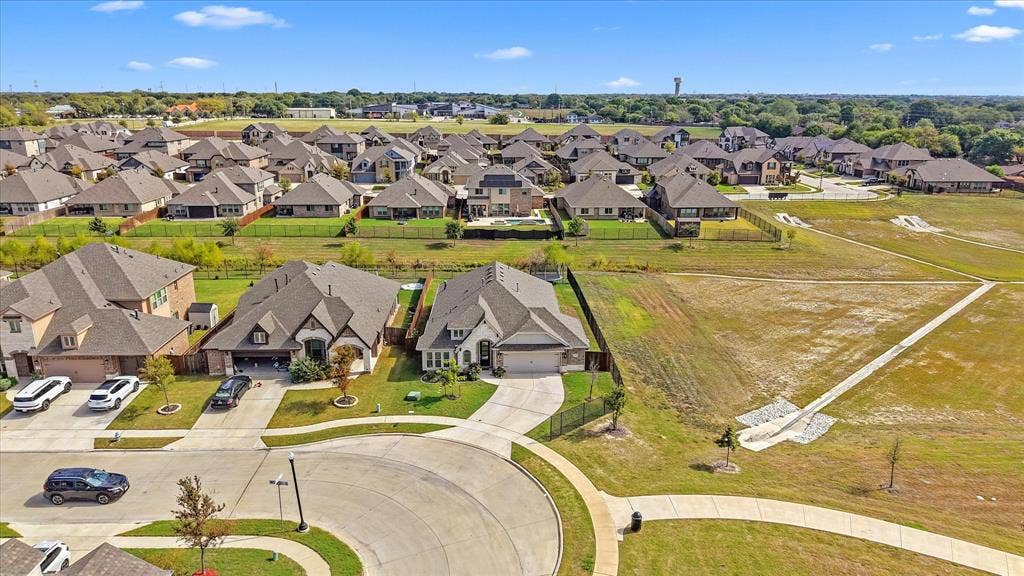 1958 Snowball Lane, Glenn Heights, TX 75154 Aerial perspective showcasing a suburban residential area with concrete cul-de-sac streets, paved sidewalks, and extensive open green space