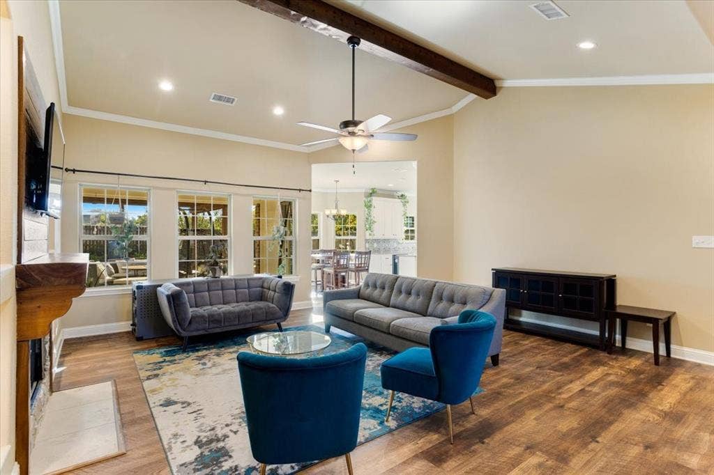 401 Mesa, Lone Oak, TX 75453 Vaulted ceiling featuring an exposed wood beam, recessed lighting, wood-finish flooring, and a stone-accented fireplace