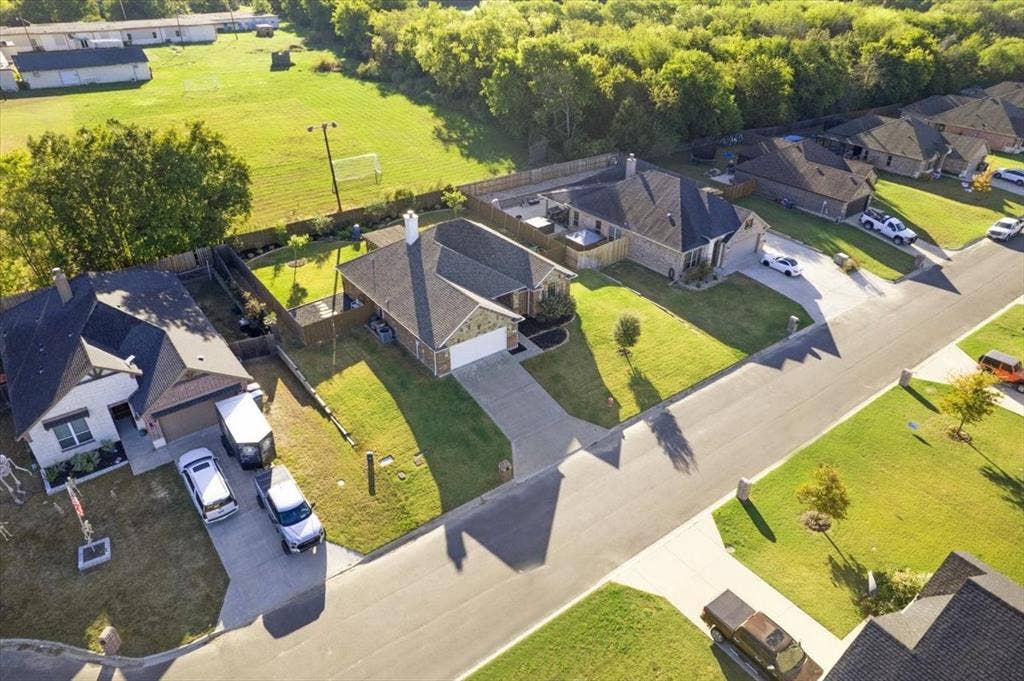 401 Mesa, Lone Oak, TX 75453 Aerial perspective featuring residential lots with concrete driveways, masonry and siding exterior finishes, composition shingle roofing, and established perimeter fencing