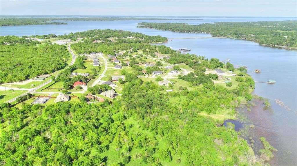 10560 Lago Vista, Quinlan, TX 75474 Aerial overview of property's location featuring a nearby body of water and a heavily wooded area