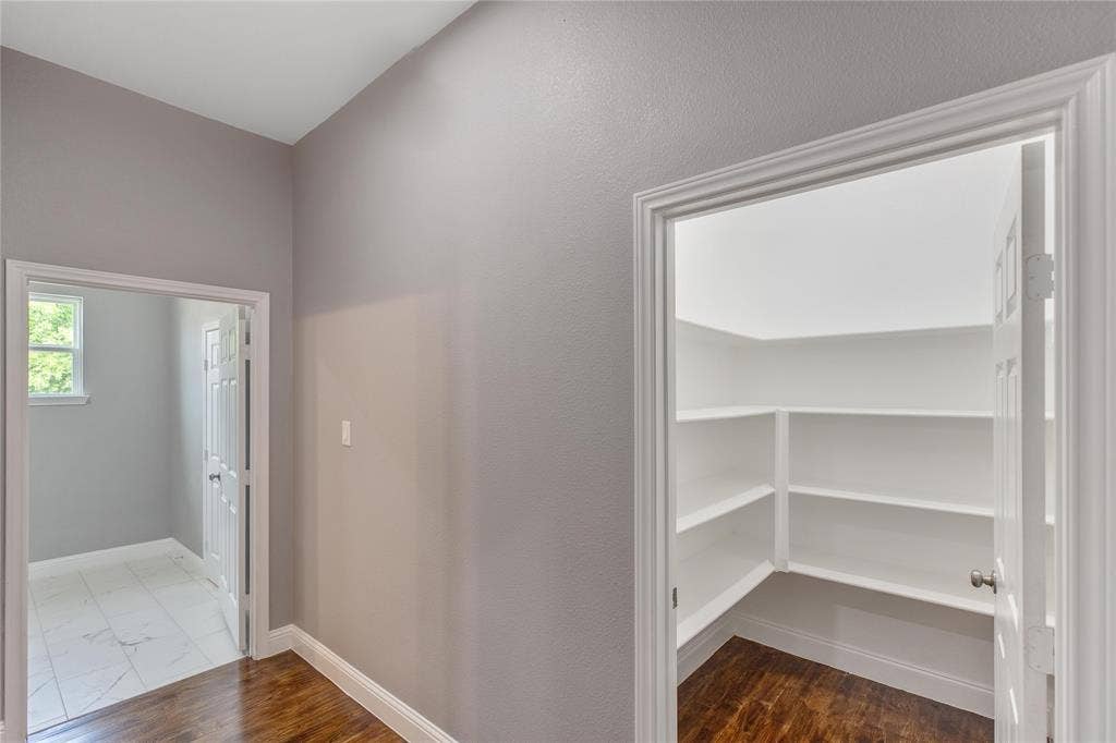 10560 Lago Vista, Quinlan, TX 75474 Hallway featuring dark wood-style floors and baseboards