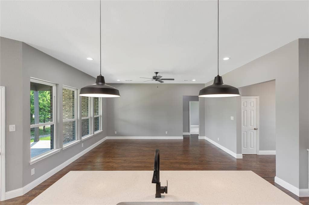 10560 Lago Vista, Quinlan, TX 75474 Unfurnished living room featuring dark wood-type flooring, recessed lighting, and a ceiling fan