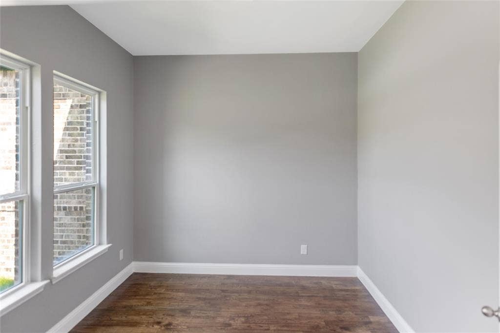 10560 Lago Vista, Quinlan, TX 75474 Empty room featuring baseboards and dark wood-type flooring