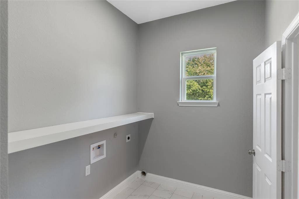 10560 Lago Vista, Quinlan, TX 75474 Washroom featuring hookup for an electric dryer, light marble finish flooring, and hookup for a washing machine