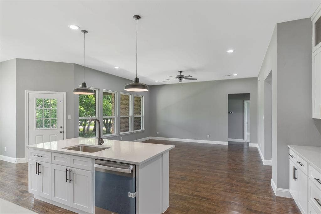 10560 Lago Vista, Quinlan, TX 75474 Kitchen with white cabinetry, hanging light fixtures, dishwasher, recessed lighting, and light stone counters