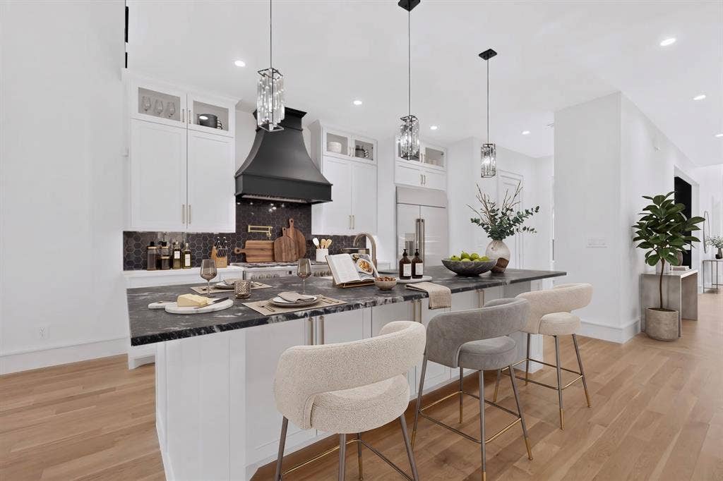 7503 Robin Road, Dallas, TX 75209 Kitchen featuring white shaker-style cabinetry, dark stone-finish island countertop, matte black statement range hood, geometric tile backsplash, and wood-finish flooring