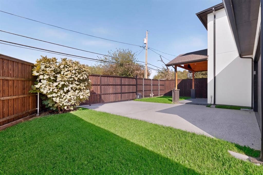 7503 Robin Road, Dallas, TX 75209 Fenced backyard featuring a manicured lawn, concrete patio, and a covered porch with wood-finish ceiling detailing