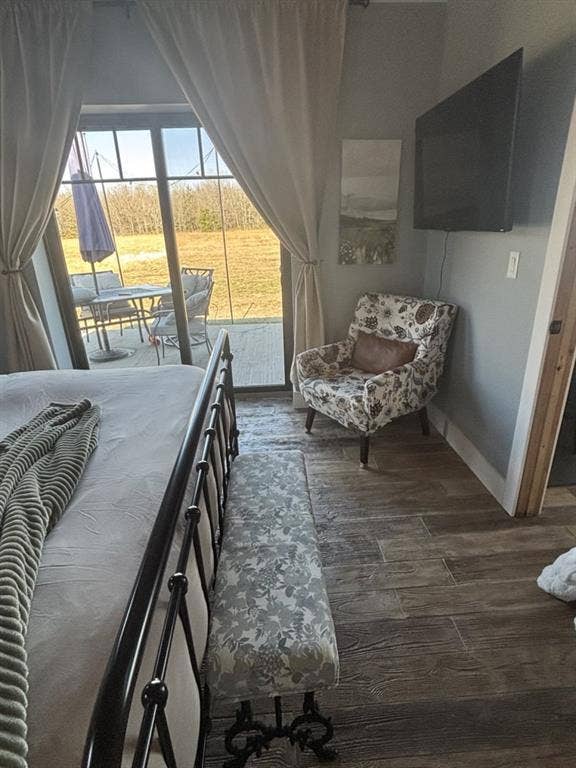 1794 County Road 4309 N, Greenville, TX 75401 Sliding glass door with muntin detailing, wood-finish flooring, and wall-mounted television bracket