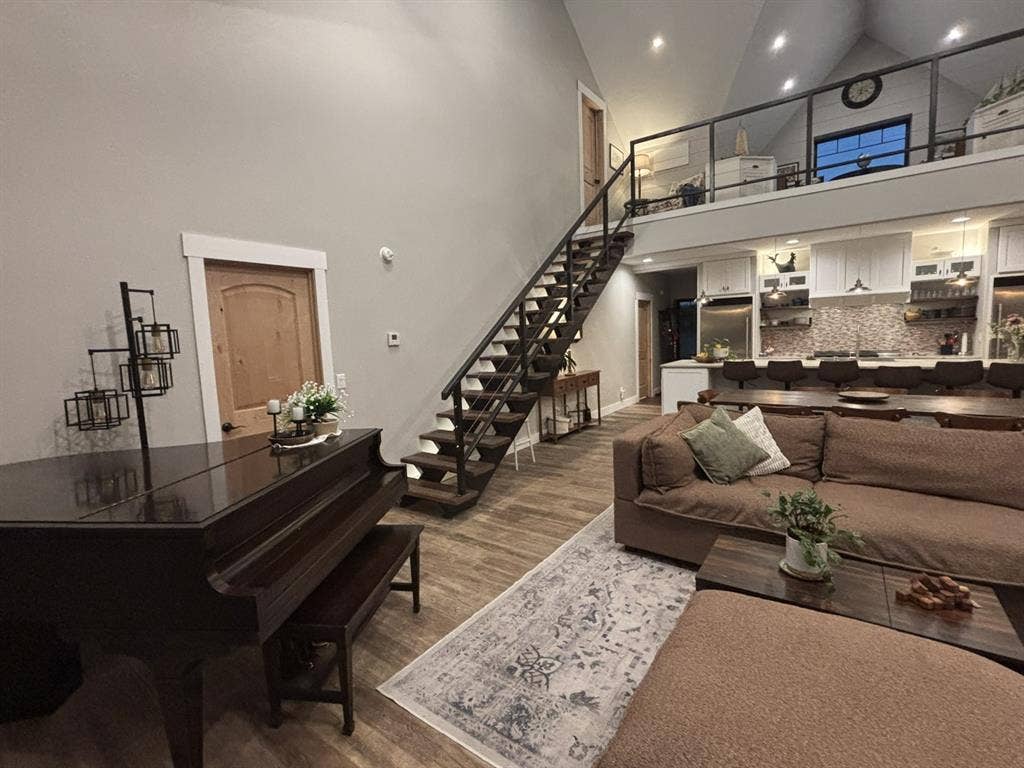 1794 County Road 4309 N, Greenville, TX 75401 Vaulted ceilings, open staircase with iron railing, lofted overlook, wood-finish flooring, and recessed lighting