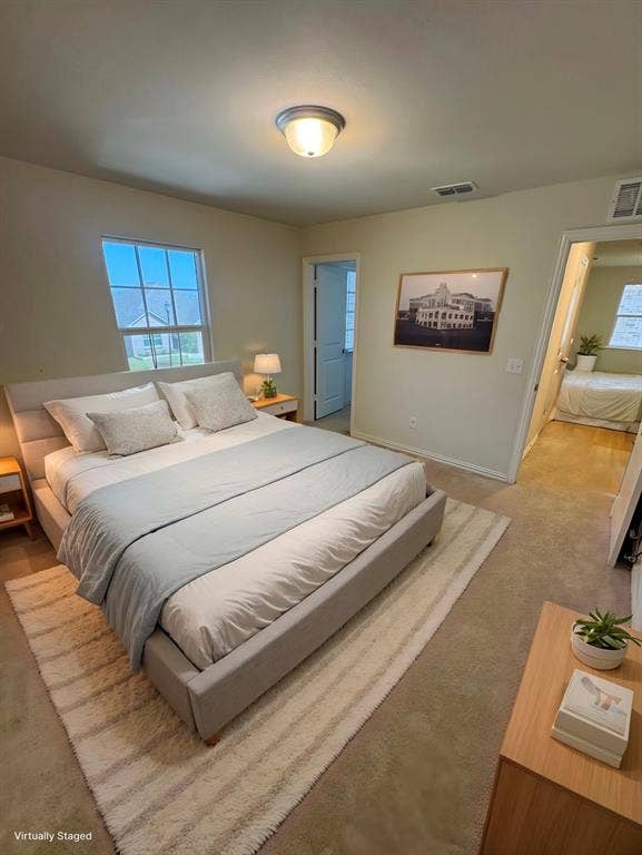 Carpeted bedroom featuring baseboards