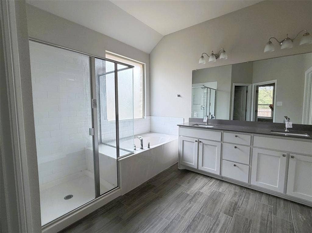 3728 Walnut Ridge Drive, Grand Prairie, TX 76065 Primary bathroom boasts of extended vanity with duel sinks. After a long day, soak in the garden tub or unwind in the steam of the walk-in shower.