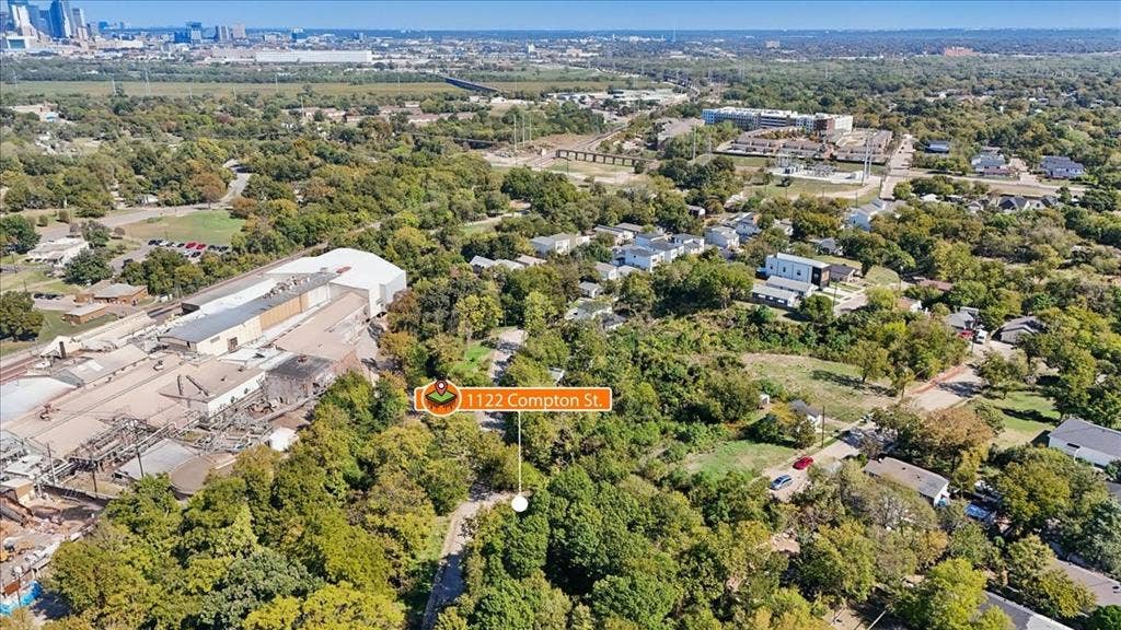 1122 Compton Street, Dallas, TX 75203 Aerial perspective featuring a wooded lot with mature trees and a paved street