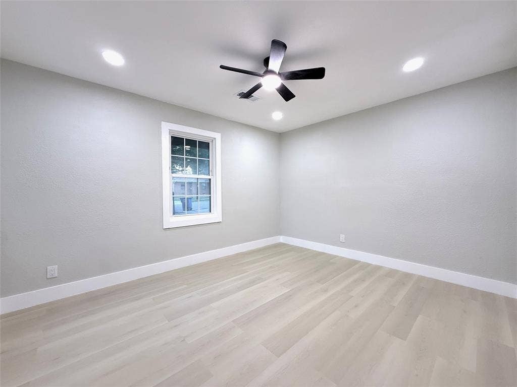 4522 Idaho Avenue, Dallas, TX 75216 Neutral-toned interior featuring wood-finish flooring, recessed lighting, a ceiling fan with an integrated light fixture, and a single-hung window with a classic frame