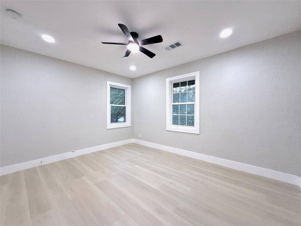 4522 Idaho Avenue, Dallas, TX 75216 Neutral wall tones, wood-finish flooring, recessed lighting, and a multi-blade ceiling fan with integrated lighting