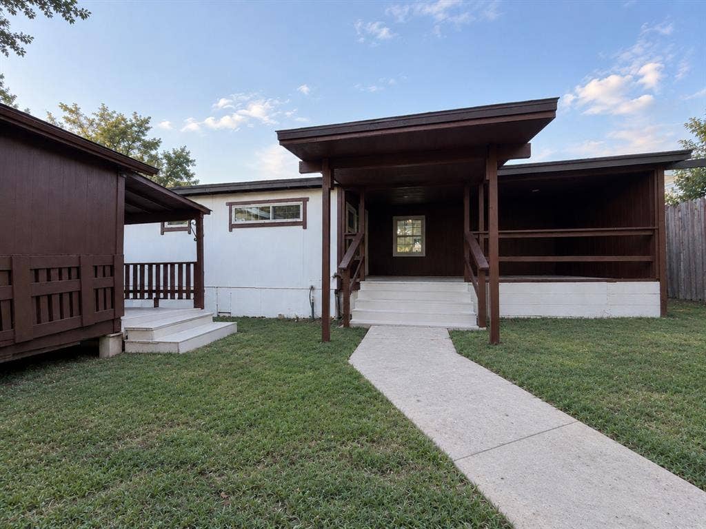4522 Idaho Avenue, Dallas, TX 75216 Exterior featuring two covered wooden decks with railings, a paved concrete walkway, and white siding