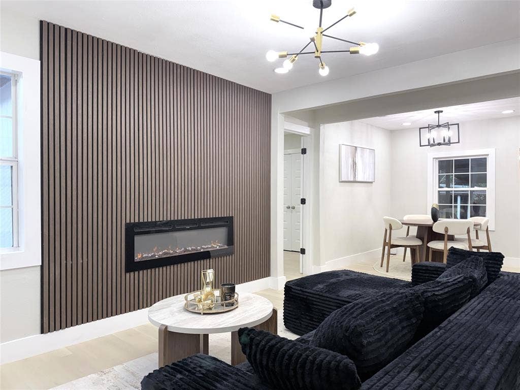 4522 Idaho Avenue, Dallas, TX 75216 Floor-to-ceiling slatted wood-finish wall accent, integrated linear electric fireplace, modern multi-arm sputnik chandelier, and recessed lighting