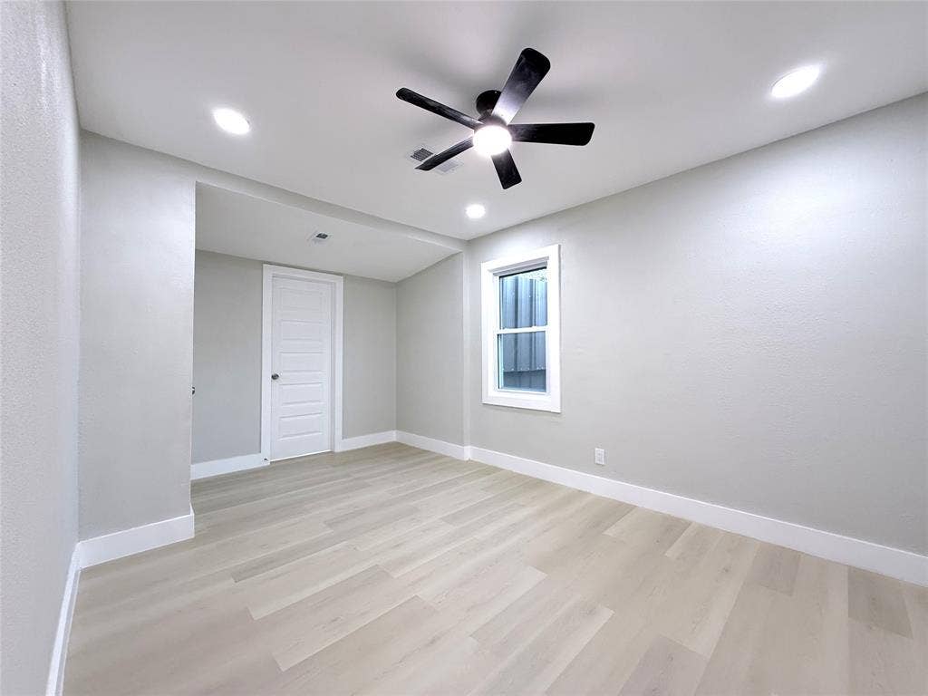 4522 Idaho Avenue, Dallas, TX 75216 Neutral interior space featuring wood-finish flooring, recessed lighting, a ceiling fan with integrated light, and a white five-panel interior door
