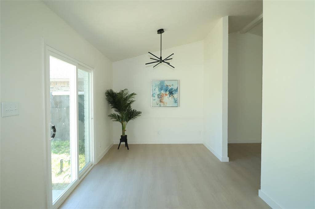 1518 Burgundy Street, Garland, TX 75040 Brand new sliding glass door, and a modern multi-arm chandelier