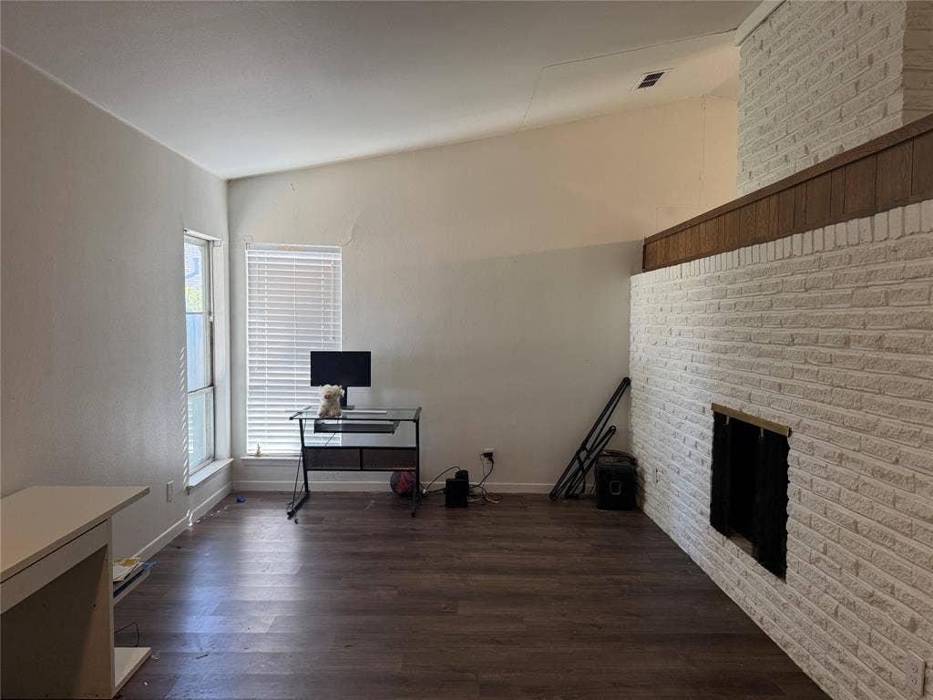3825 Eugene Court N, Irving, TX 75062 Vaulted ceilings, wood-finish flooring, and white-painted brick fireplace with a wood-trim mantle