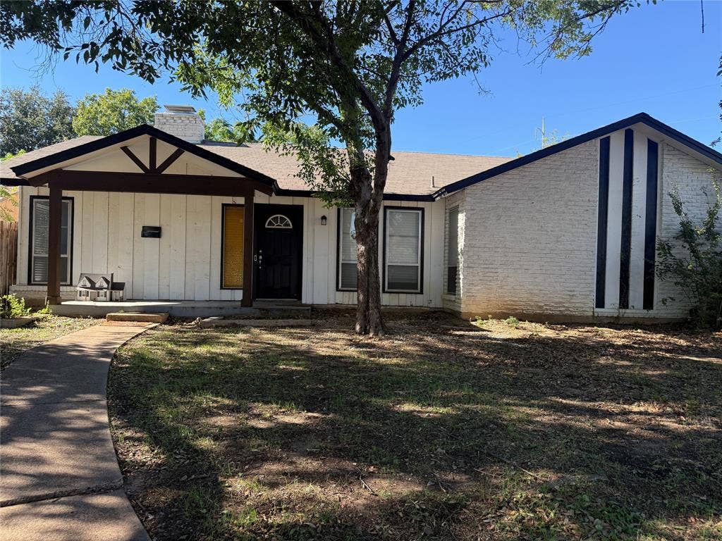 3825 Eugene Court N, Irving, TX 75062 Exterior featuring a board-and-batten and painted brick facade, covered front porch with wooden support beams, and vertical accent trim