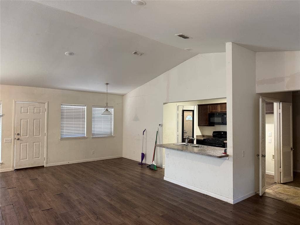 3825 Eugene Court N, Irving, TX 75062 Vaulted ceilings, wood-finish flooring, breakfast bar with stone-finish countertop, dual-window configuration, and paneled entry door