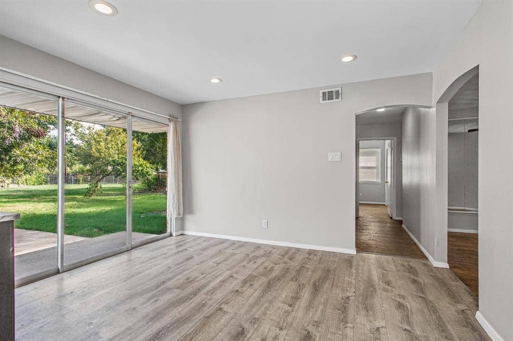 1220 Colfax Circle, Richardson, TX 75080 Interior space featuring wood-finish flooring, recessed lighting, and large sliding glass doors opening to a backyard