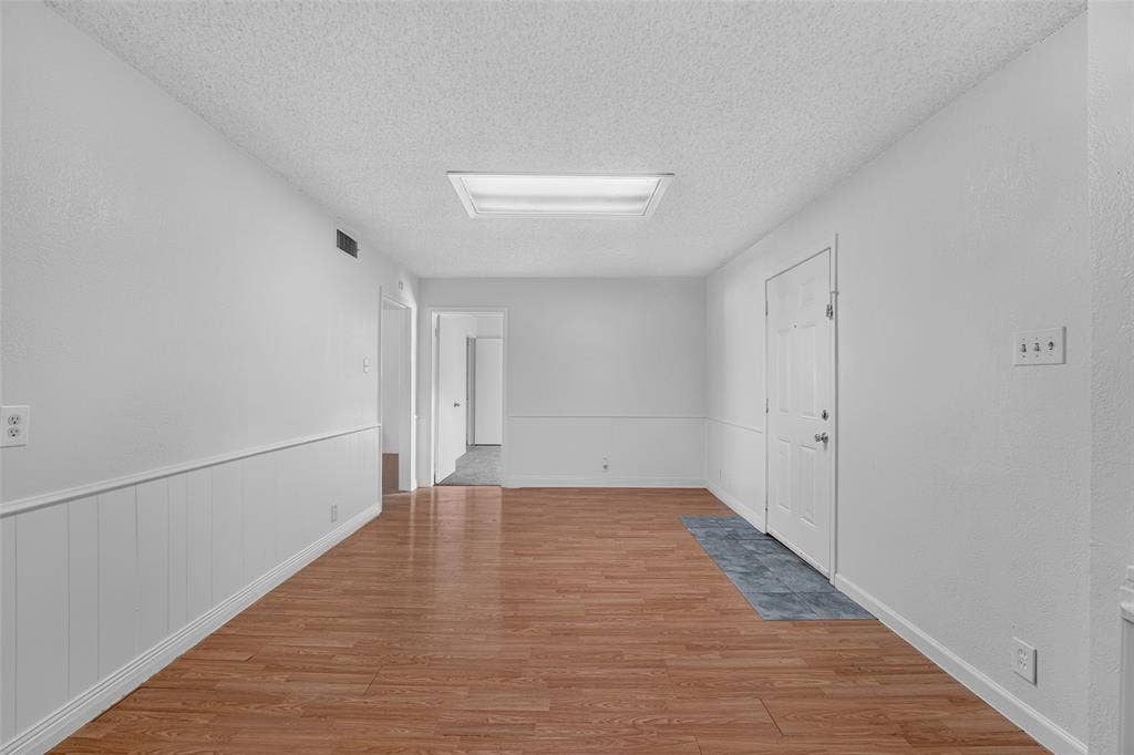 3532 Hilton Drive, Mesquite, TX 75150 Interior space featuring wood-finish flooring, wainscoting, recessed ceiling lighting, and a six-panel door