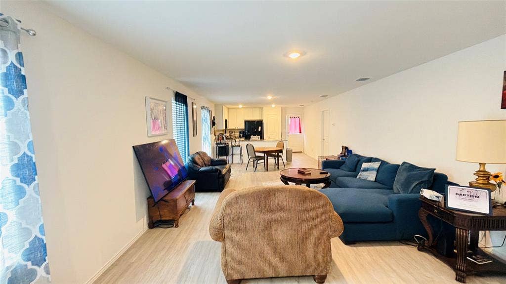 Open-concept interior featuring wood-finish flooring and recessed lighting
