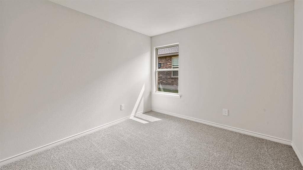 Neutral wall color with light gray carpeting and white trim