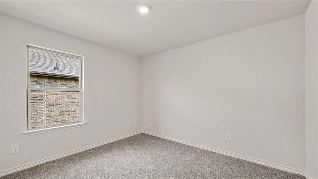 Recessed ceiling lighting, neutral wall paint, single pane window, and gray carpeting