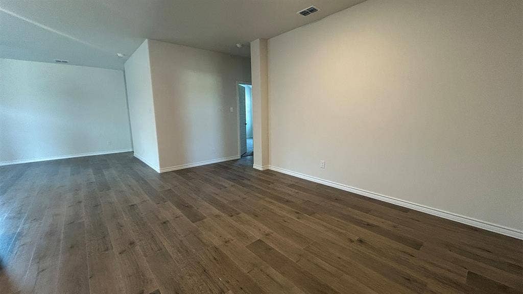 410 Campfield Drive, Caddo Mills, TX 75135 Neutral-toned interior space featuring wood-finish flooring and smooth, high-reaching ceilings