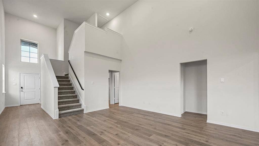 5727 Sunshine Lane, Crandall, TX 75114 High ceilings, wood-finish flooring, two-story entry, carpeted staircase, and an upper-level landing