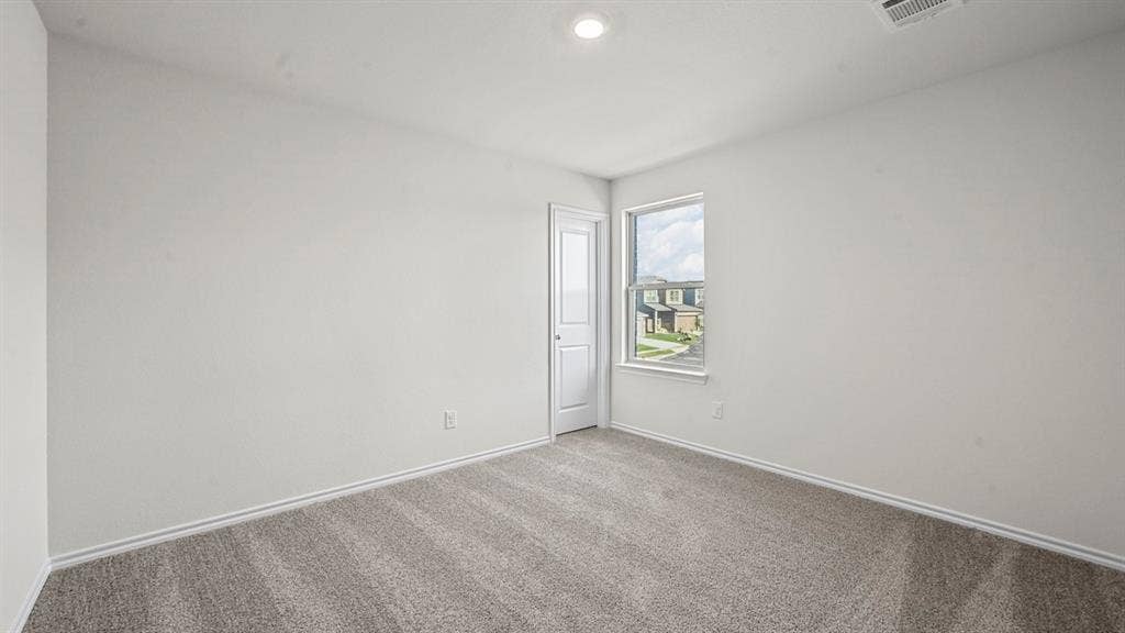5727 Sunshine Lane, Crandall, TX 75114 Recessed ceiling light, neutral wall color, window with exterior elements, carpeted flooring, and a white door
