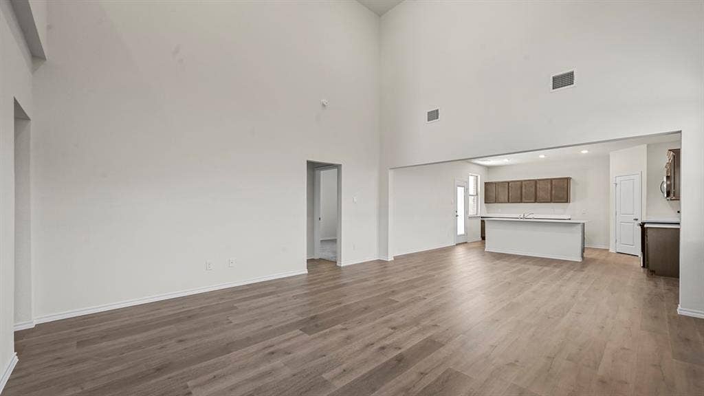 5727 Sunshine Lane, Crandall, TX 75114 Soaring ceilings, wood-finish flooring, and an open-concept layout