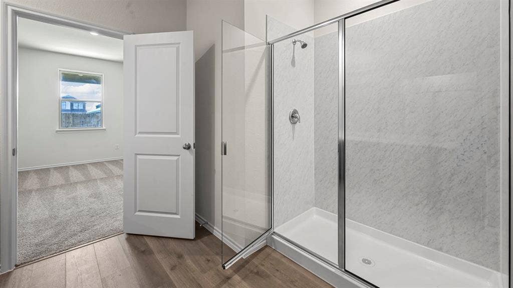 5727 Sunshine Lane, Crandall, TX 75114 Walk-in shower with clear glass enclosure and tile-look wall panels