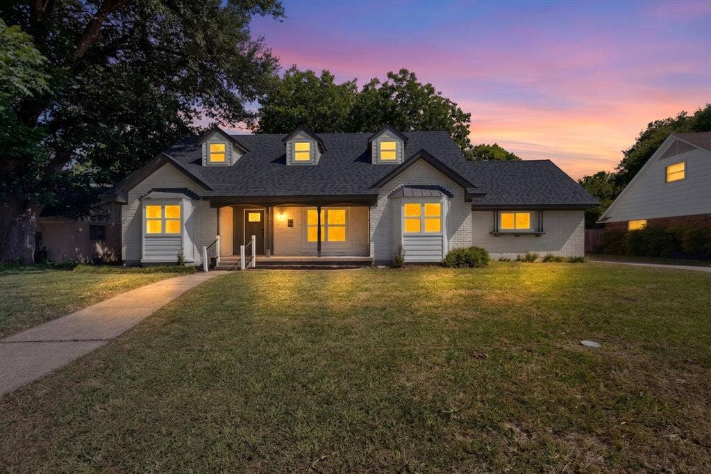 550 Glen Oaks Boulevard, Dallas, TX 75232 Single-story brick exterior featuring a covered front porch, dormer windows, and a multi-gabled roofline