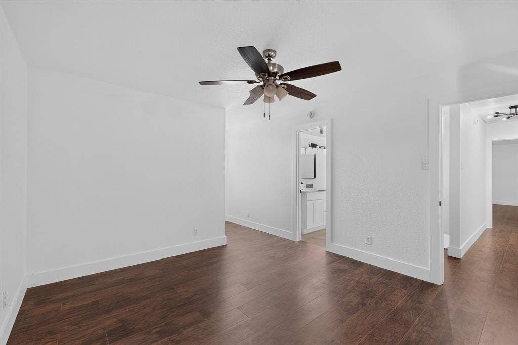 550 Glen Oaks Boulevard, Dallas, TX 75232 Interior space featuring wood-finish flooring, white walls, and a ceiling-mounted light fixture with a multi-blade fan
