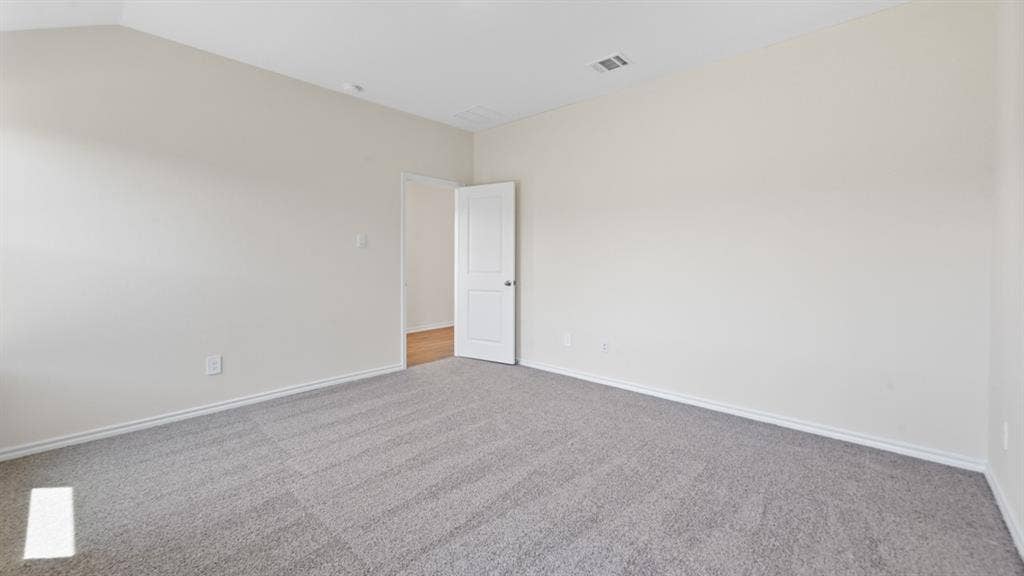 5739 Sunshine Lane, Crandall, TX 75114 Spacious room featuring light neutral wall paint, gray carpeting, and white baseboards
