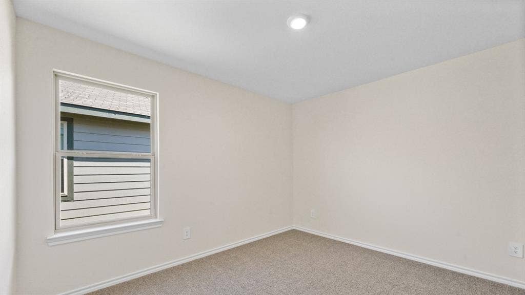5739 Sunshine Lane, Crandall, TX 75114 Neutral wall paint, carpet flooring, a window with white trim, and a recessed ceiling light fixture