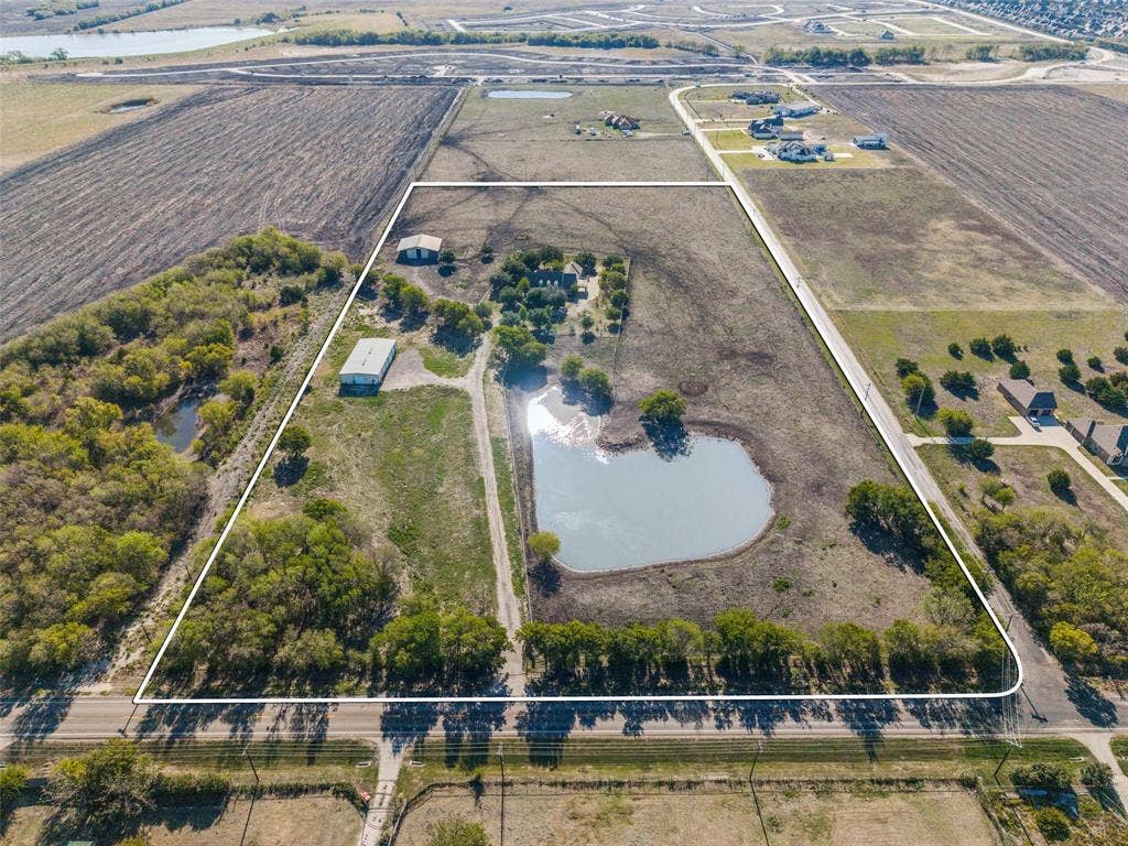 1957 E Fm 550, Rockwall, TX 75032 Expansive acreage featuring a private heart-shaped pond, barn, workshop and mature tree clusters