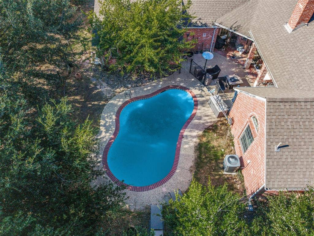 1957 E Fm 550, Rockwall, TX 75032 Free-form gunite pool with brick coping and expansive aggregate patio.