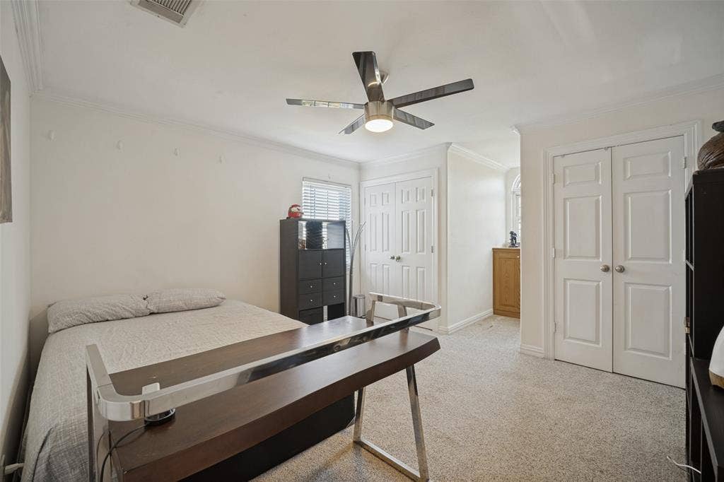 1957 E Fm 550, Rockwall, TX 75032 Neutral-toned room featuring a multi-blade ceiling fan, crown molding, dual-panel interior doors, and built-in cabinetry