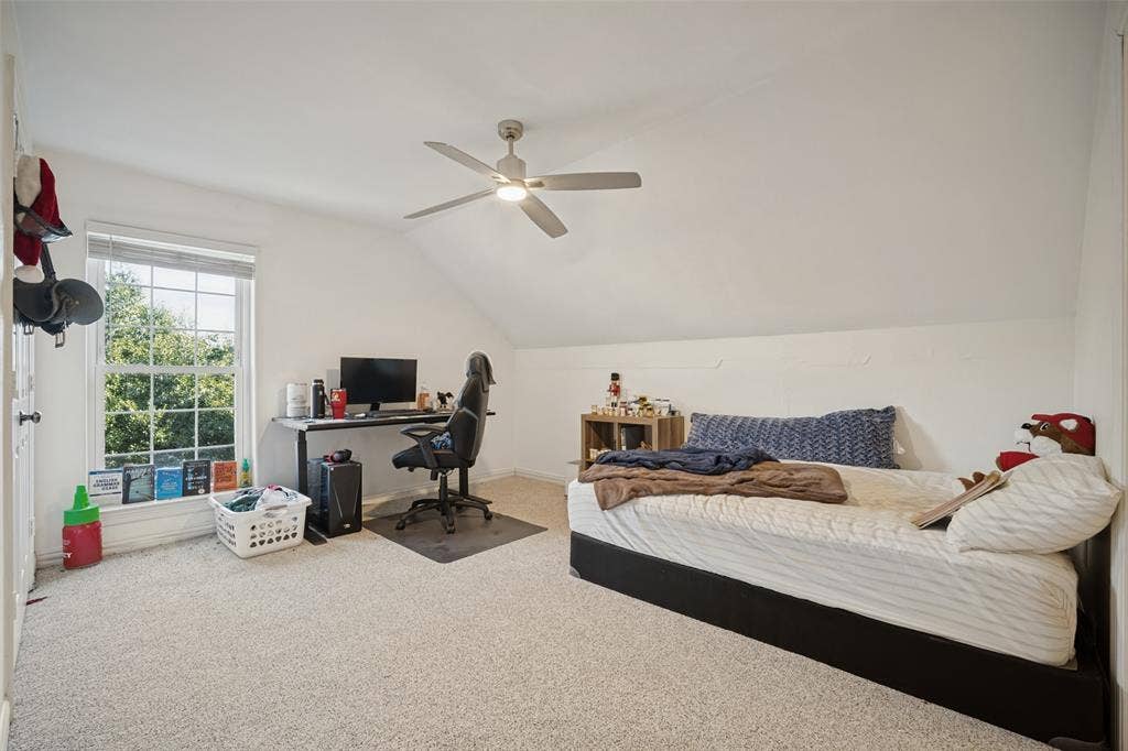 1957 E Fm 550, Rockwall, TX 75032 Bedroom featuring slanted ceilings, carpeting, a multi-lite window, and a ceiling fan with integrated lighting and ensuite bathroom.