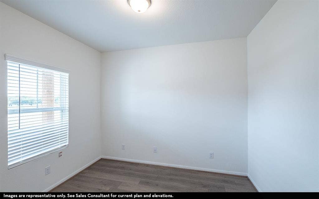 Wood-finish flooring, neutral walls, flush-mount ceiling lighting, and horizontal window blinds