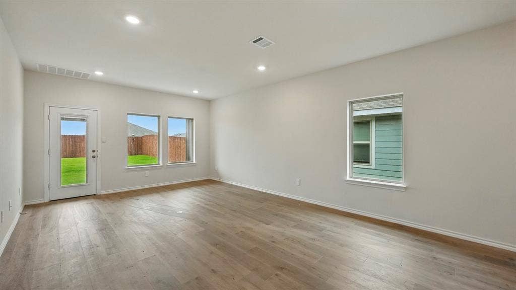 2620 Ocean View Grove, Crandall, TX 75114 Spacious room featuring wood-finish flooring, recessed lighting, and ample natural light from multiple windows